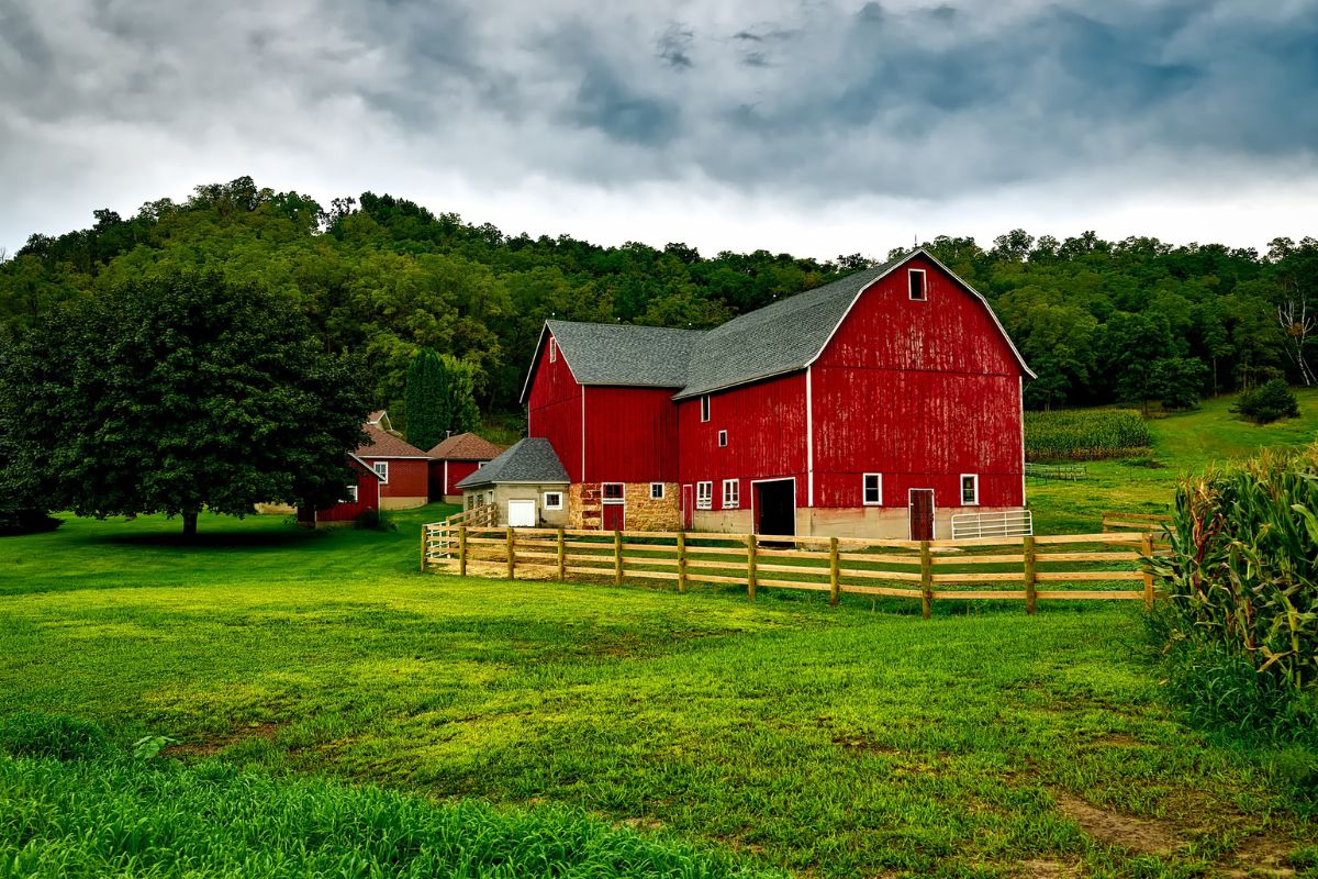 A big red barn in a countryside.