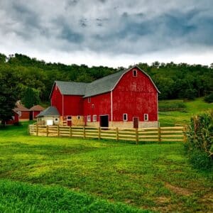 A big red barn in a countryside.